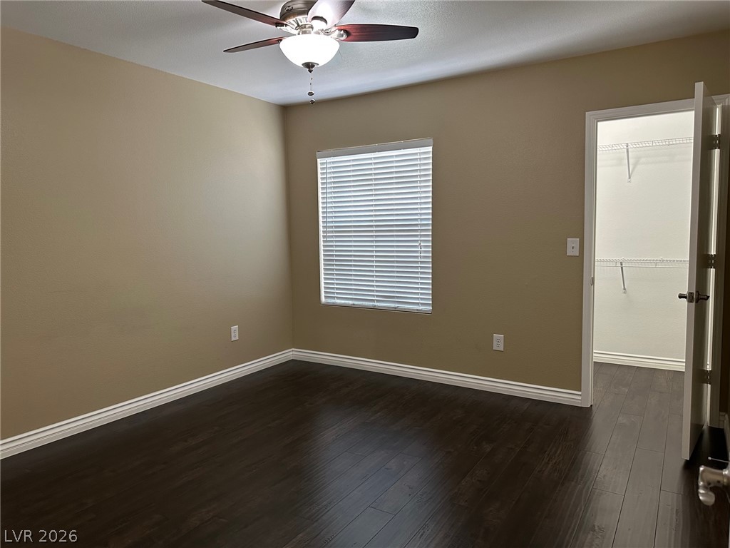 7255 West Sunset Road, Unit 2078 Las Vegas, NV 89113 - Photo 8 of 34 A well-proportioned bedroom showcases dark wood flooring and a practical walk-in closet.