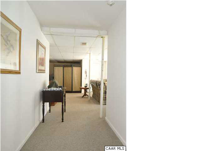 126 North Boston Road Troy, VA 22974 - Photo 22 of 39 Hallway leading from the stairs to the rest of the basement. Game room is behind the photographer.