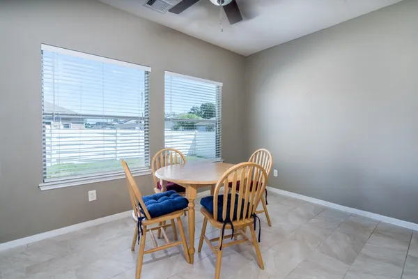 a dining room with furniture and windows