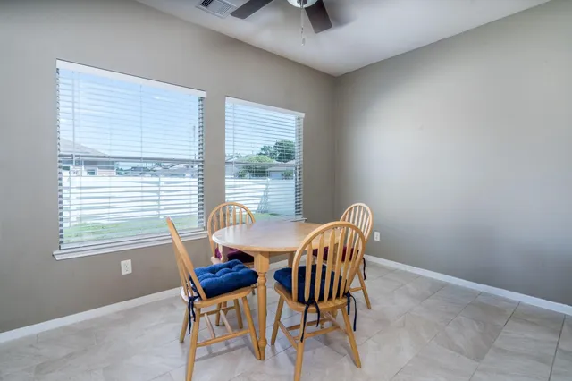 a dining room with furniture and windows