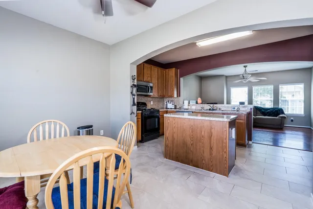 a kitchen with a sink a counter top space and stainless steel appliances
