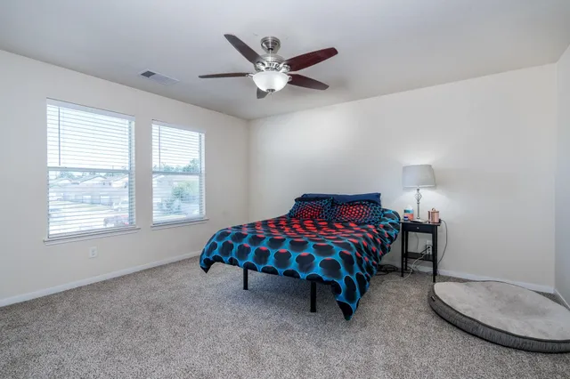 a bedroom with a bed and a chandelier