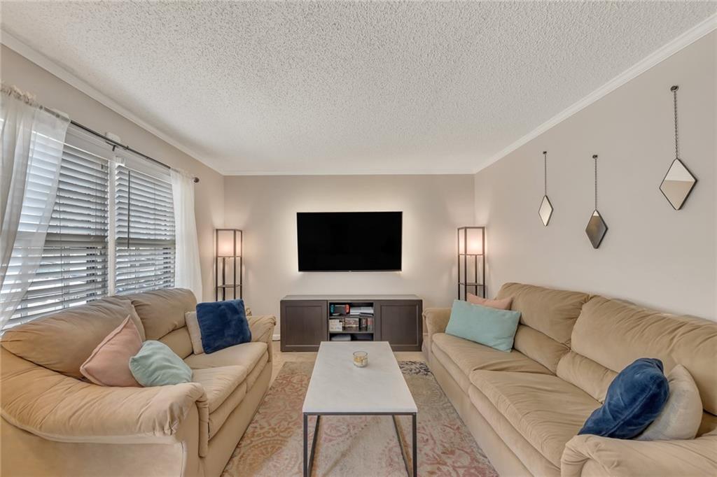 161 Lablanc Way Northwest Atlanta, GA 30327 - Photo 1 of 1 a living room with furniture and a flat screen tv