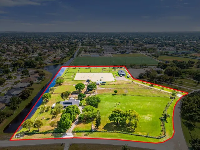 a view of swimming pool with a garden and trees
