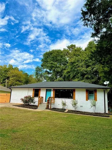 a front view of a house with a garden