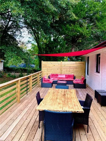 a view of a patio with table and chairs and wooden floor
