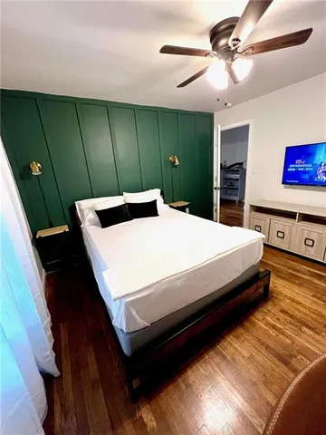 a bed sitting in a bedroom next to a window