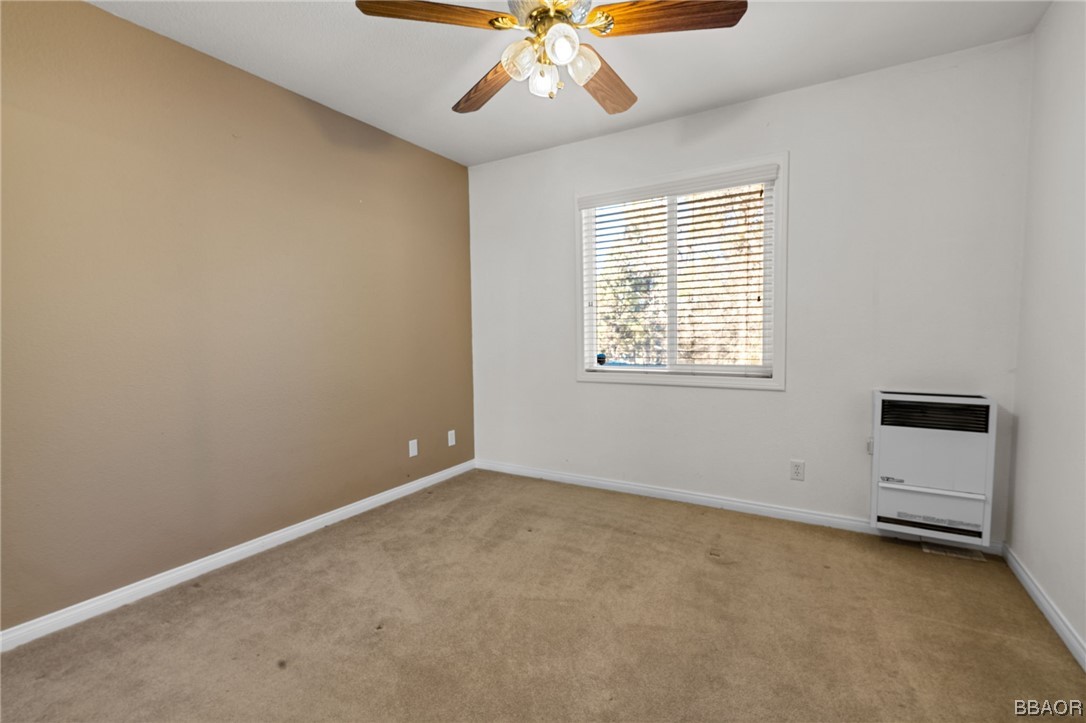 307 Riverside Avenue Sugarloaf, CA 92386 - Photo 16 of 31 an empty room with chandelier fan and windows