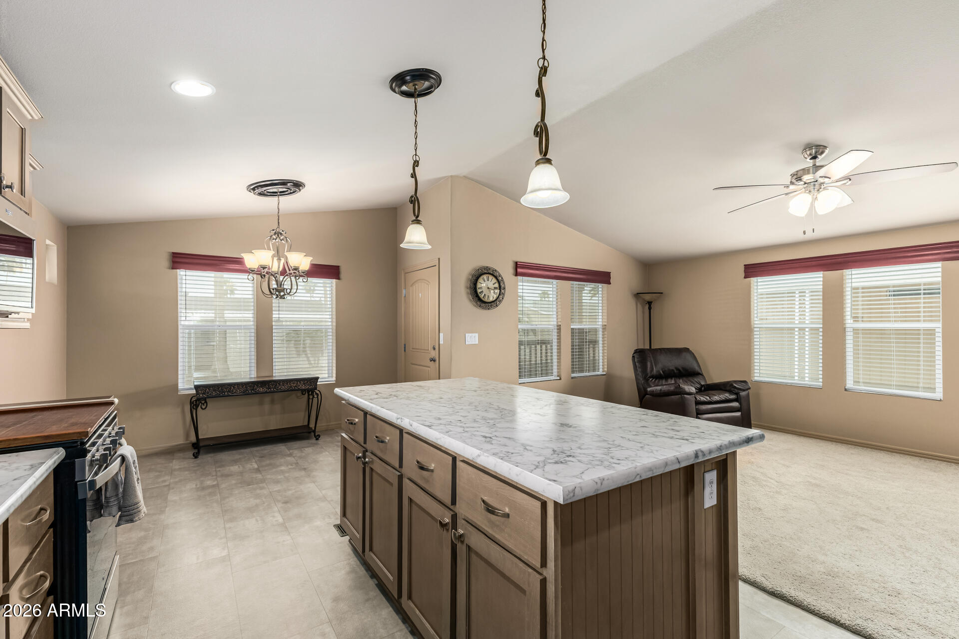 9302 East Broadway Road, Unit 117 Mesa, AZ 85208 - Photo 11 of 24 a kitchen with a stove center island and couches
