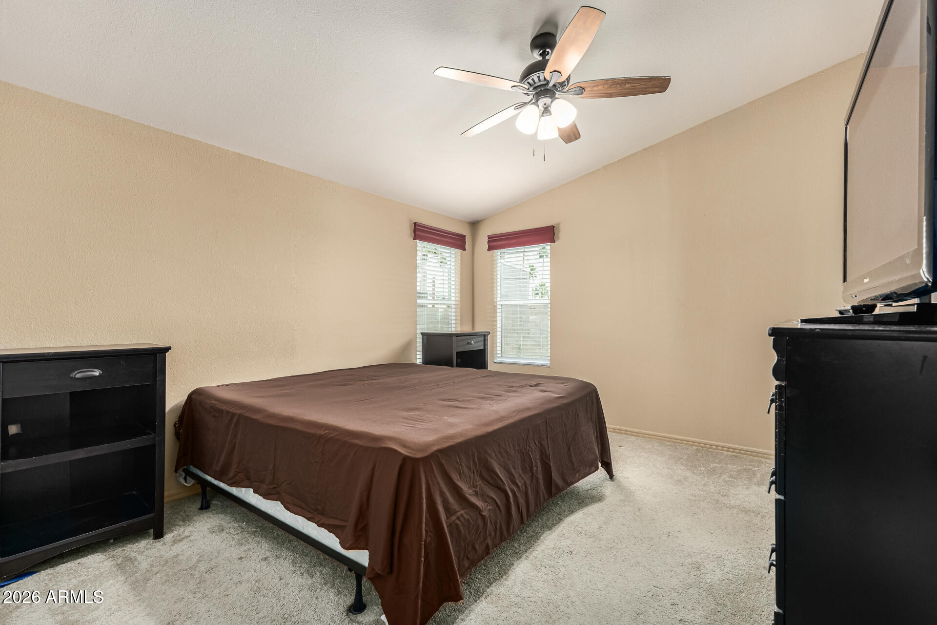 9302 East Broadway Road, Unit 117 Mesa, AZ 85208 - Photo 12 of 24 a bedroom with a bed and a chandelier