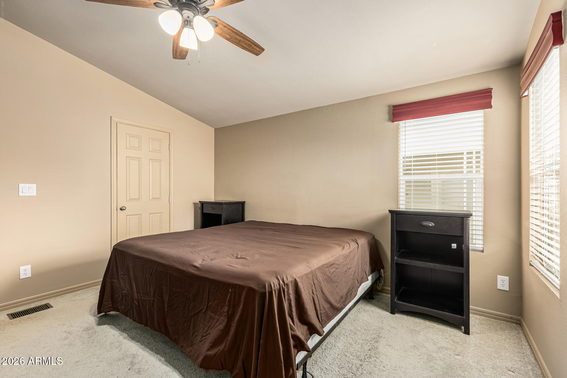 9302 East Broadway Road, Unit 117 Mesa, AZ 85208 - Photo 13 of 24 a bedroom with a bed and a chandelier