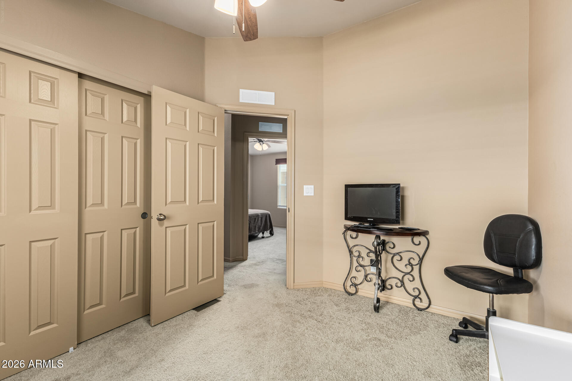 9302 East Broadway Road, Unit 117 Mesa, AZ 85208 - Photo 17 of 24 a view of a livingroom with furniture and a flat screen tv