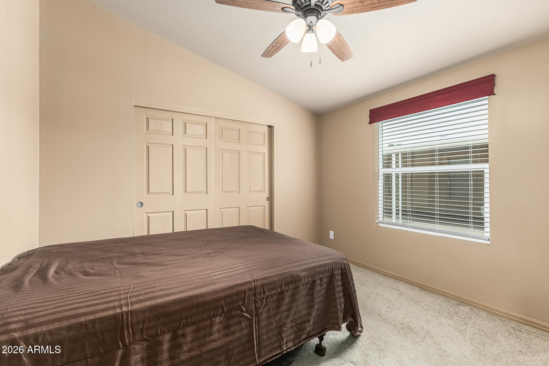 9302 East Broadway Road, Unit 117 Mesa, AZ 85208 - Photo 18 of 24 a bedroom with a bed and a chandelier