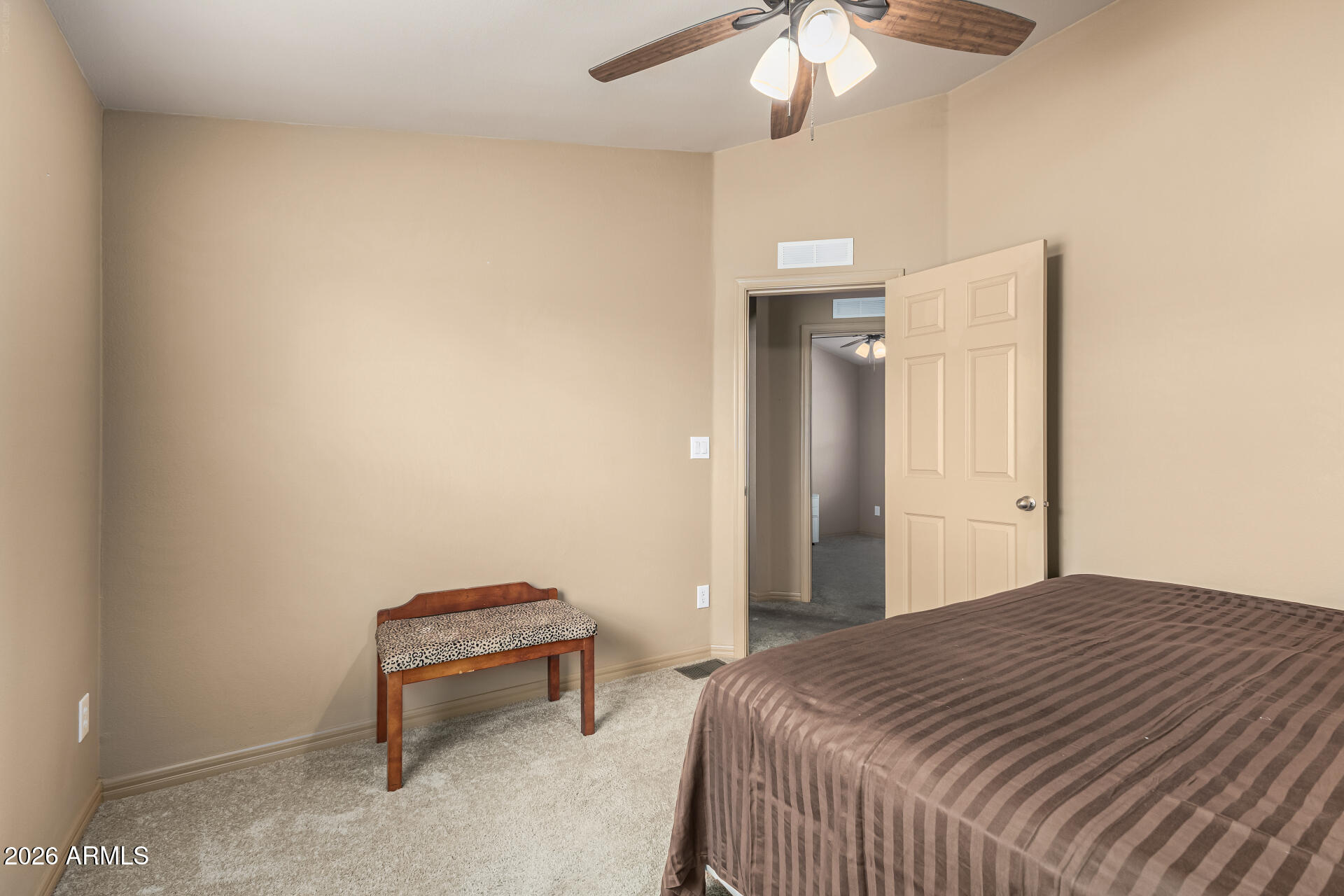 9302 East Broadway Road, Unit 117 Mesa, AZ 85208 - Photo 19 of 24 a bedroom with a bed and a chandelier