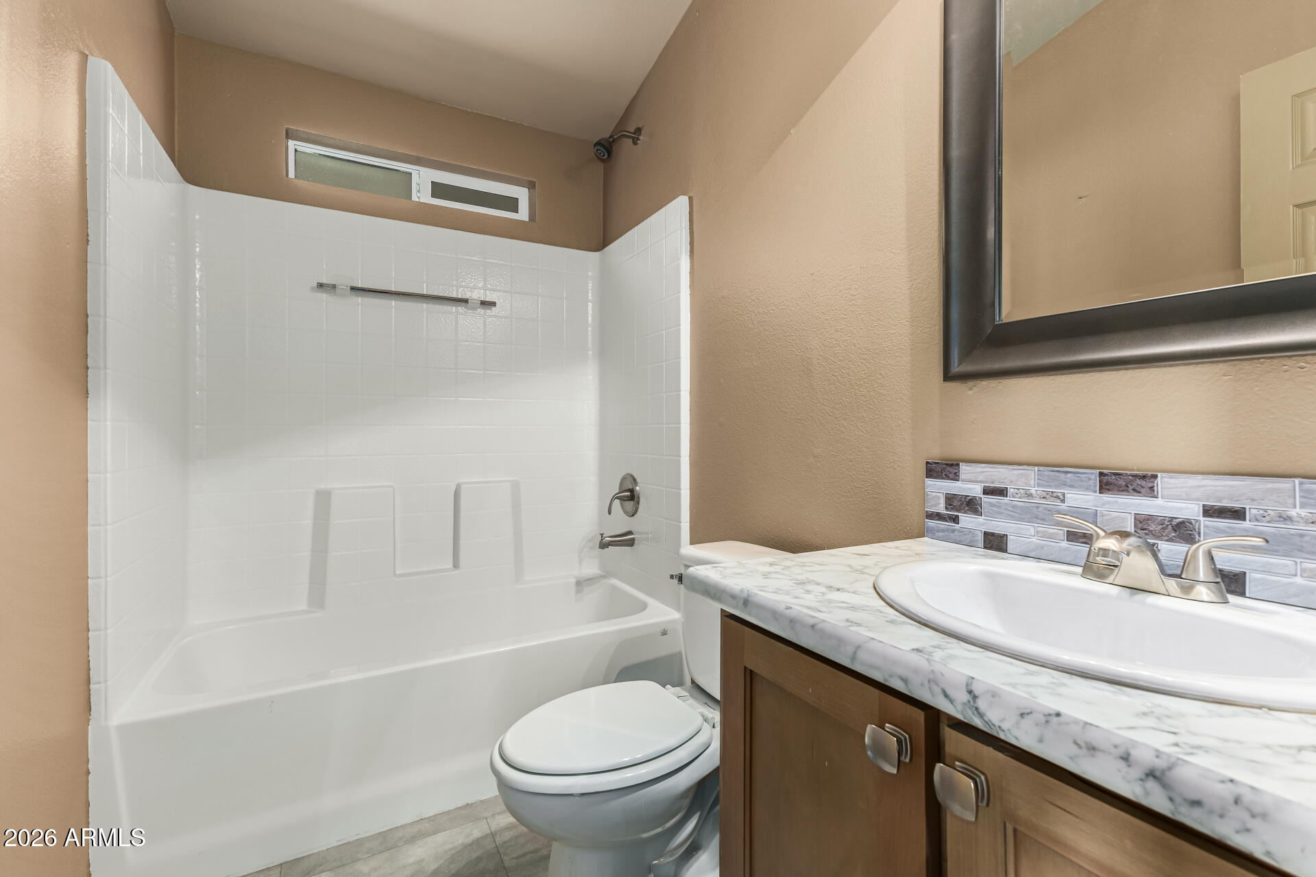 9302 East Broadway Road, Unit 117 Mesa, AZ 85208 - Photo 20 of 24 a bathroom with a granite countertop sink toilet and shower