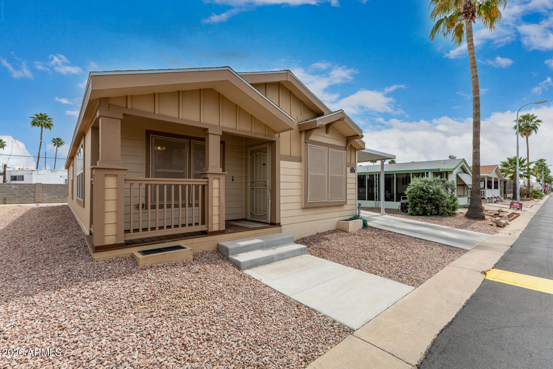 9302 East Broadway Road, Unit 117 Mesa, AZ 85208 - Photo 2 of 24 a view of a house with a yard