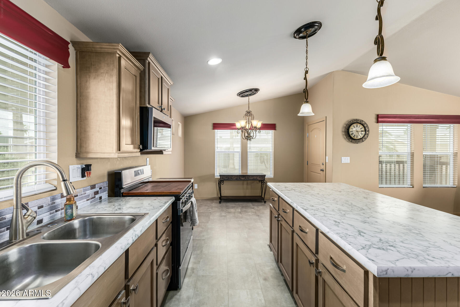 9302 East Broadway Road, Unit 117 Mesa, AZ 85208 - Photo 10 of 24 a kitchen with stainless steel appliances granite countertop a sink a oven and a wooden floors
