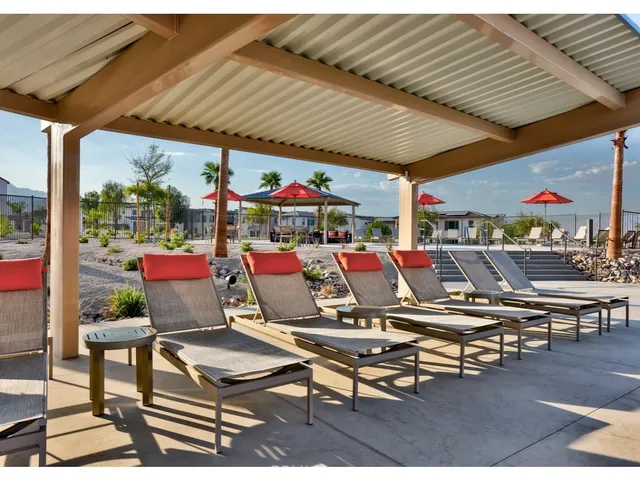 a view of a swimming pool with outdoor seating
