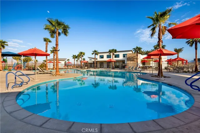 a room with stainless steel appliances a table chairs and wooden floor