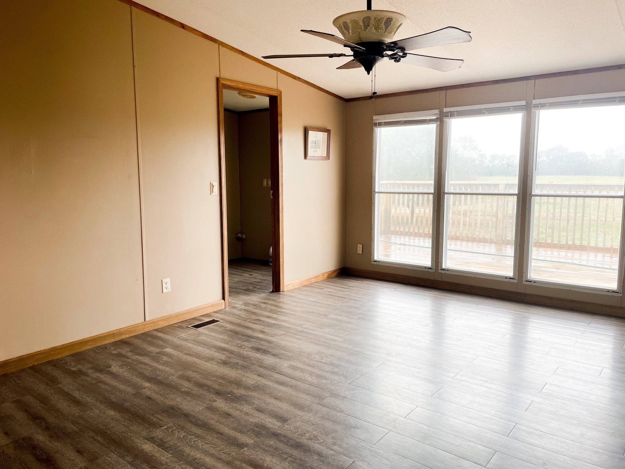 4778 South Qualls Road Adams, TN 37010 - Photo 3 of 7 a view of an empty room with a window and wooden floor