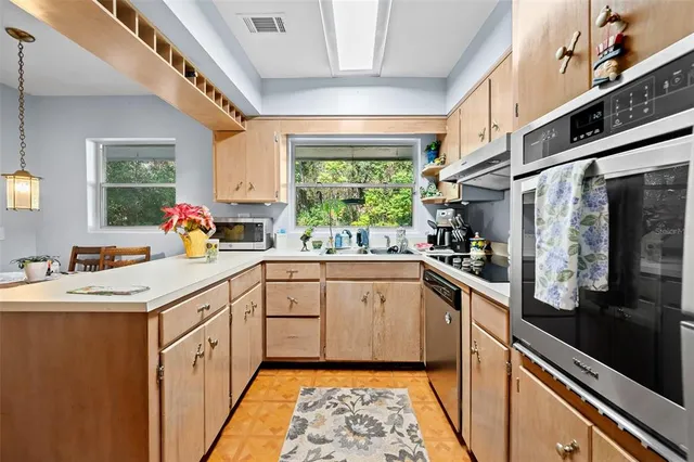 a kitchen with a sink stove and cabinets