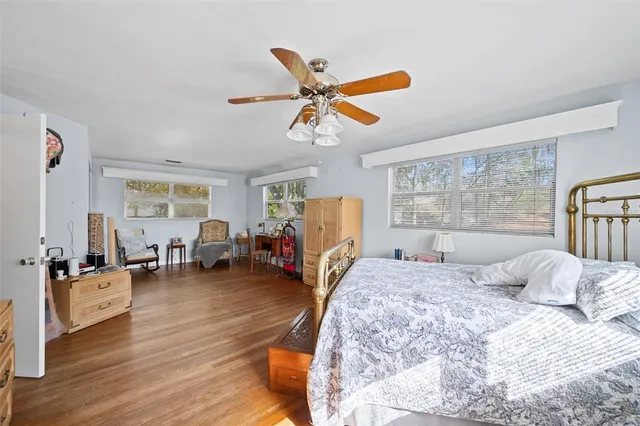 a bedroom with a bed couch and a window