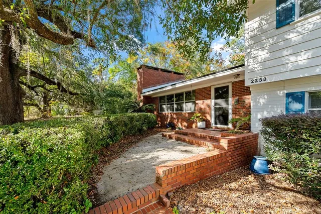 a view of house with backyard outdoor seating and green space