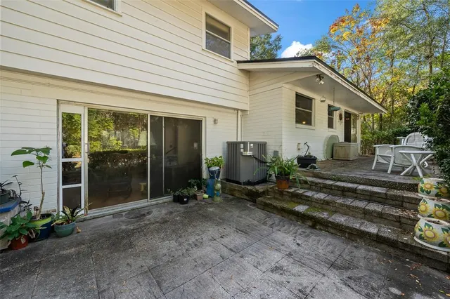 a view of a house with backyard sitting area and garden