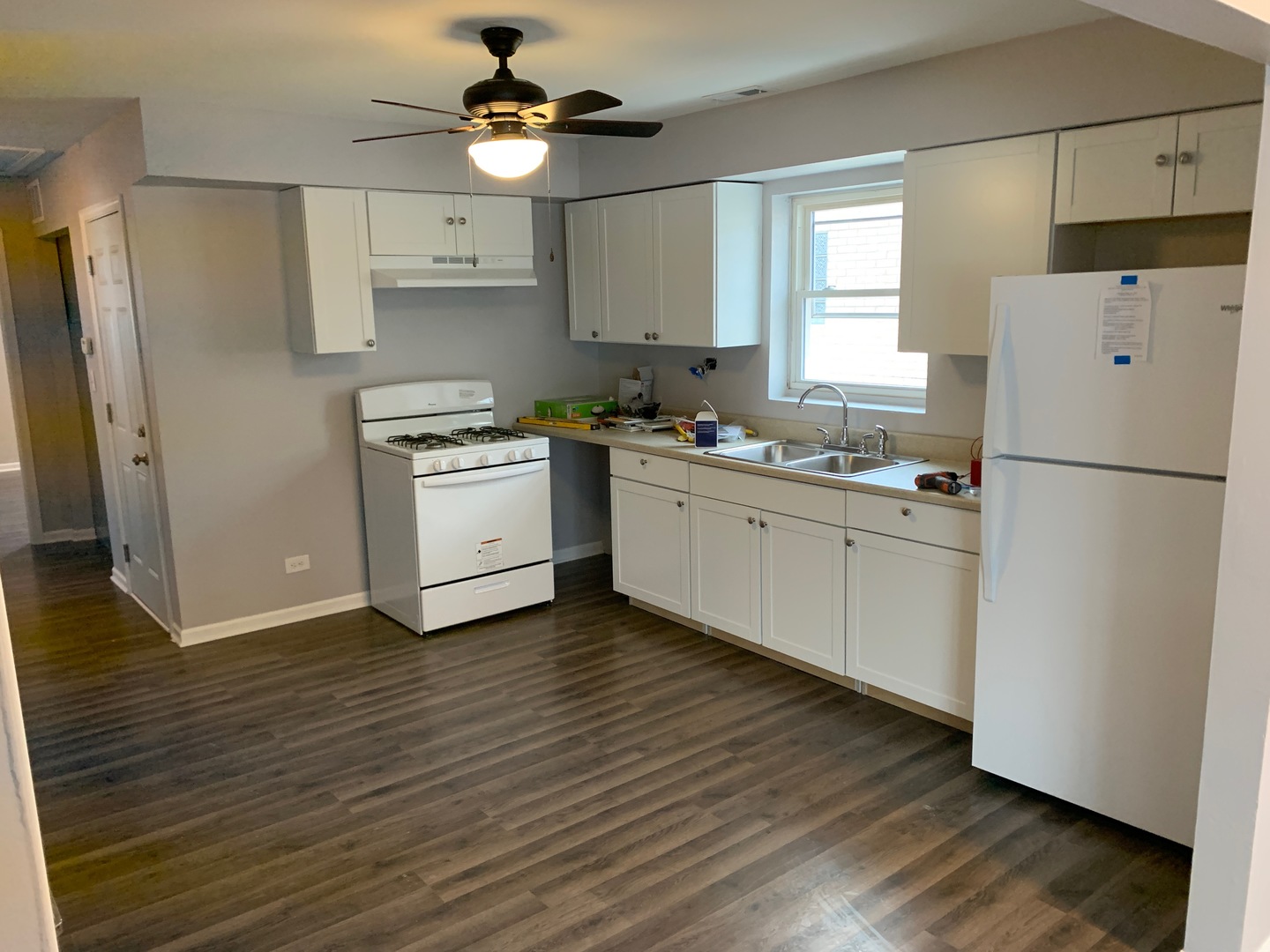 824 South 13th Avenue Maywood, IL 60153 - Photo 3 of 10 a kitchen with stainless steel appliances a refrigerator sink and wooden floor