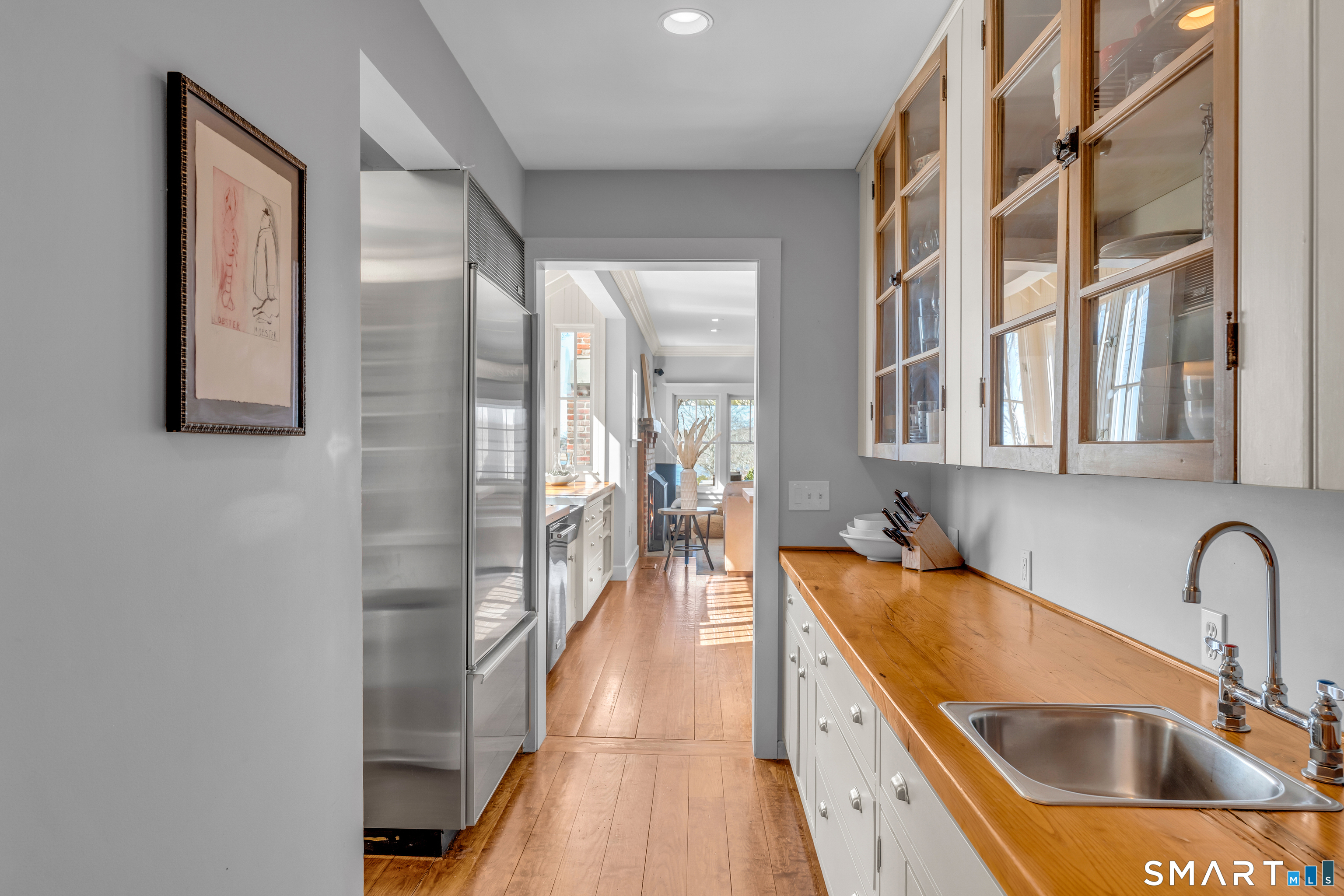 100 Old Black Point Road East Lyme, CT 06357 - Photo 14 of 40 The butlers pantry has a wet bar with plenty of counter space and storage including an additional enclosed pantry with a door to the patio and grill area.