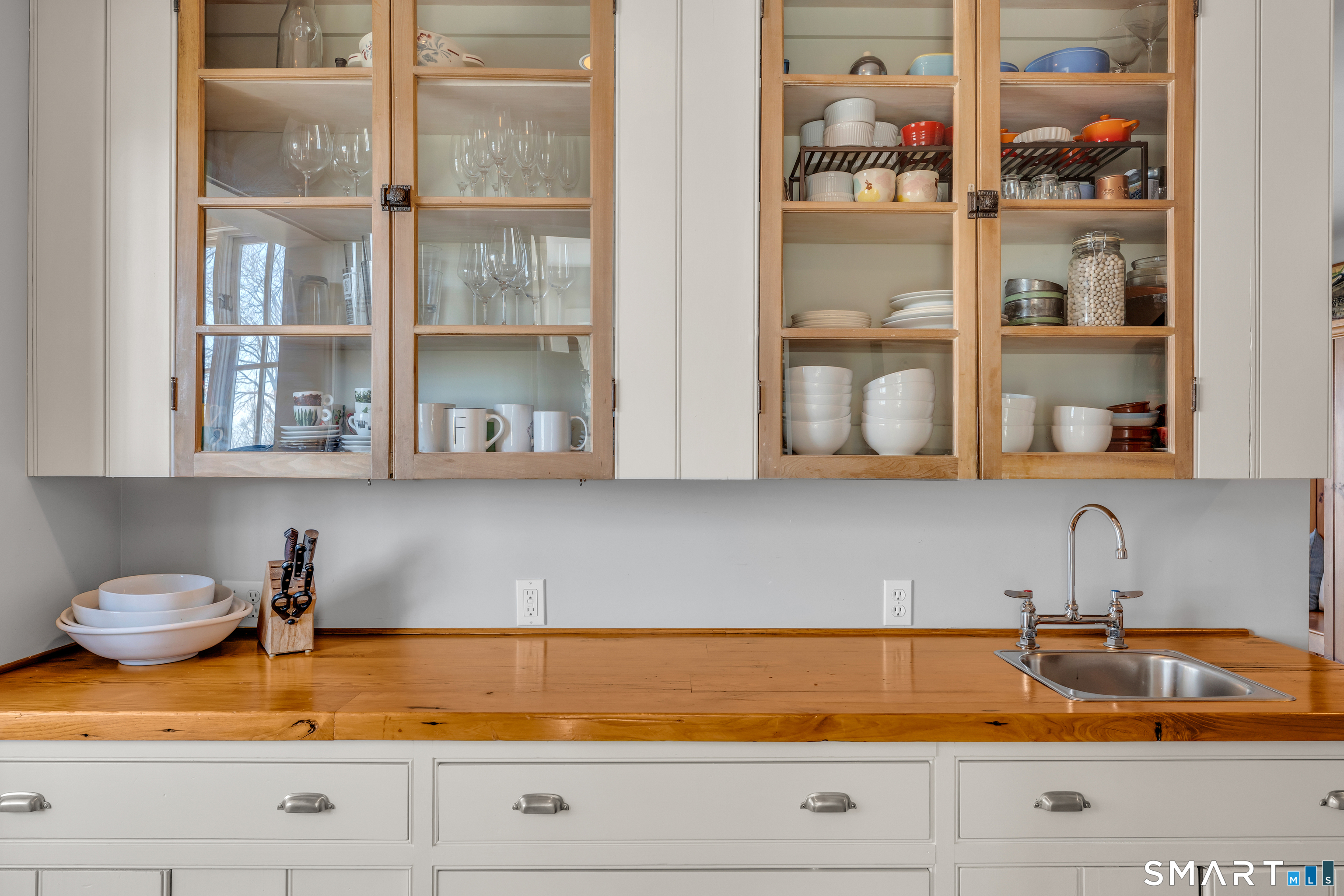 100 Old Black Point Road East Lyme, CT 06357 - Photo 15 of 40 The butlers pantry has a wet bar with plenty of counter space and storage including an additional enclosed pantry with a door to the patio and grill area.