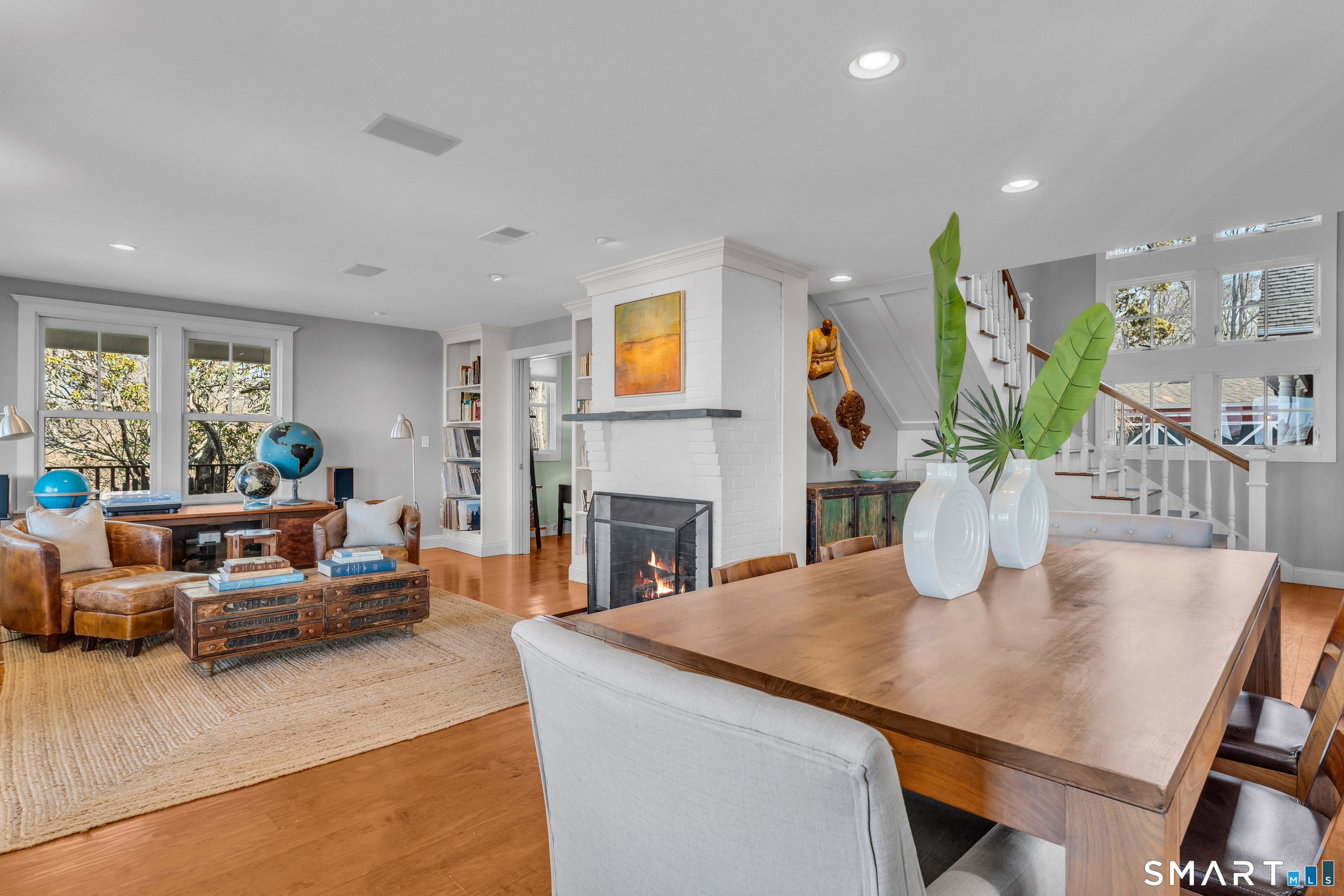 100 Old Black Point Road East Lyme, CT 06357 - Photo 16 of 40 A cozy sitting area is open to the dining space and offers a gas fireplace, built-ins and water views.