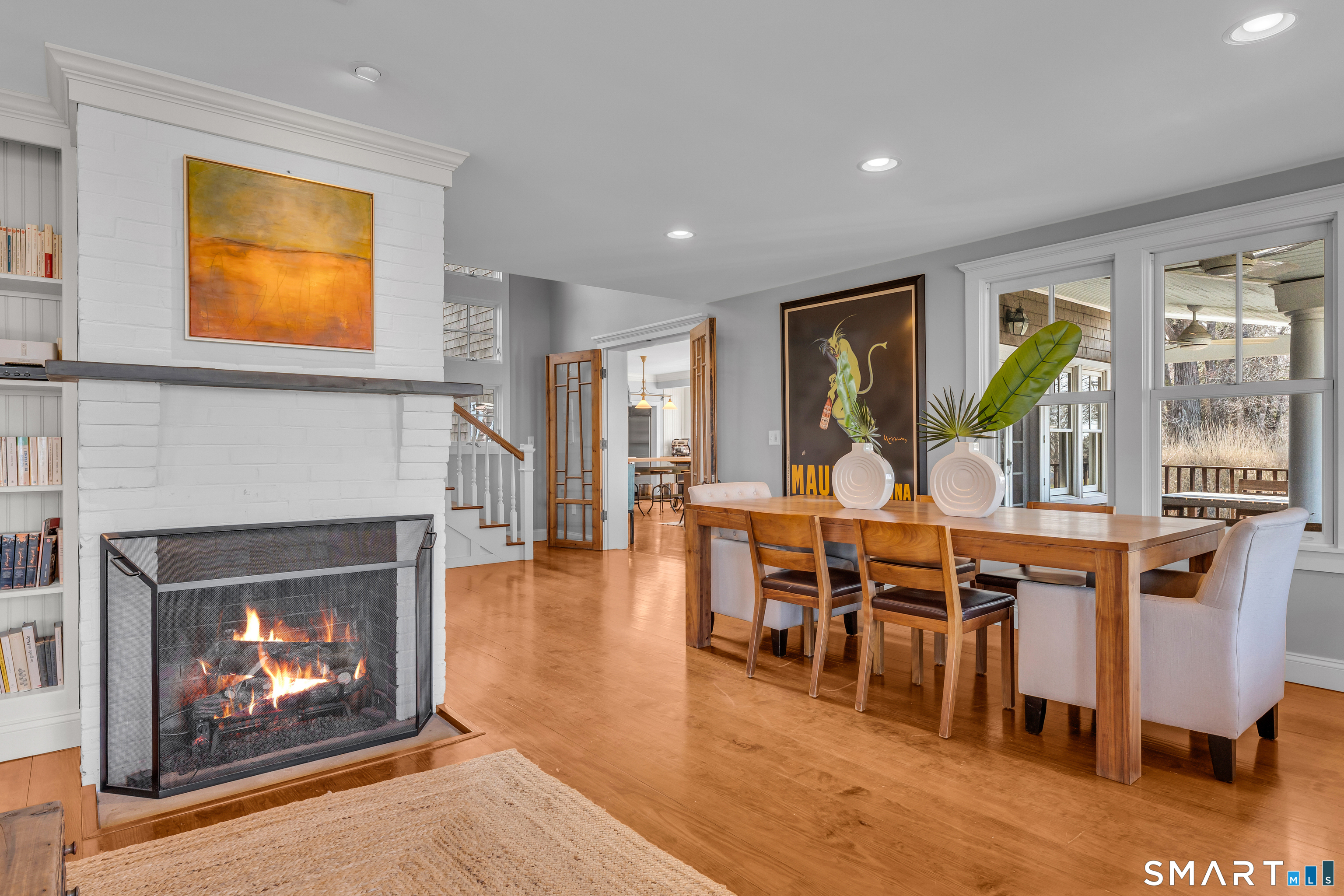 100 Old Black Point Road East Lyme, CT 06357 - Photo 17 of 40 The dining room has a cozy gas fireplace, built-ins and porch access and water views.