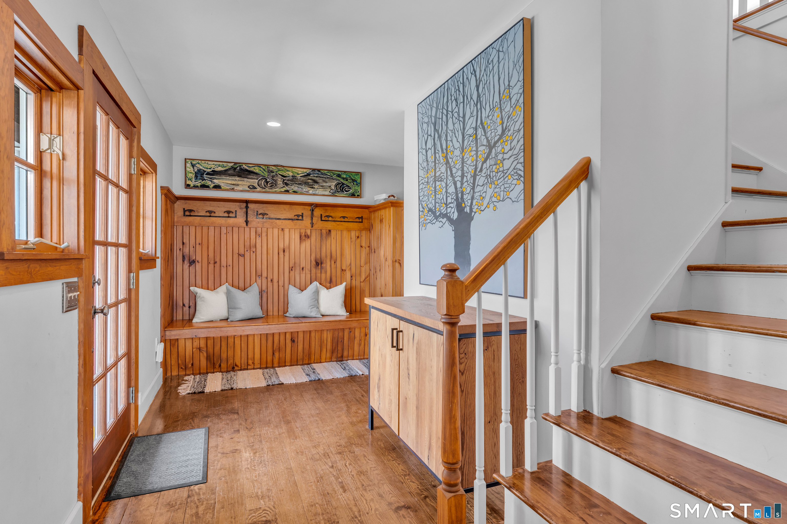 100 Old Black Point Road East Lyme, CT 06357 - Photo 21 of 40 The entry foyer includes a built in mud room area, a 1/2 bath and one of 2 staircases leading directly to the in home office and a large media space.