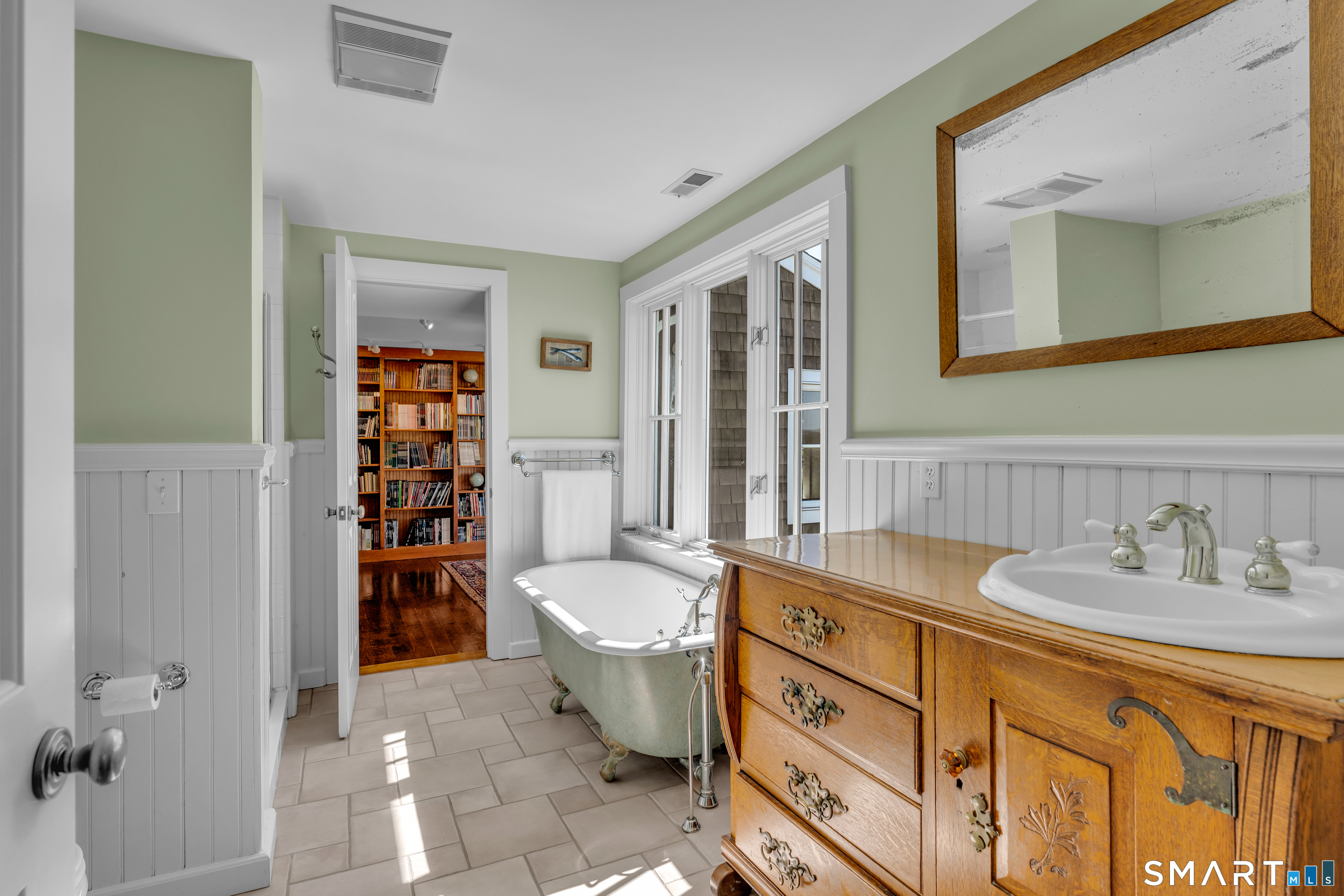 100 Old Black Point Road East Lyme, CT 06357 - Photo 26 of 40 The unique primary bath has an antique vanity a separate shower and claw foot tub.