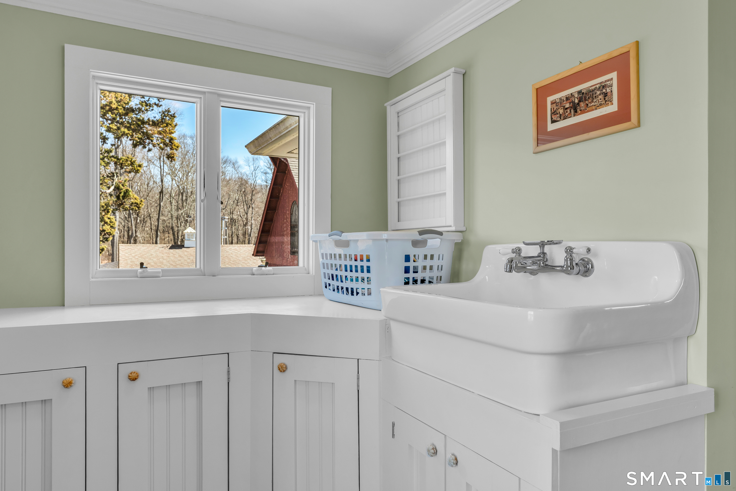 100 Old Black Point Road East Lyme, CT 06357 - Photo 28 of 40 The second floor laundry room has built-ins for storage, a large sink and is conveniently located by the bedrooms.