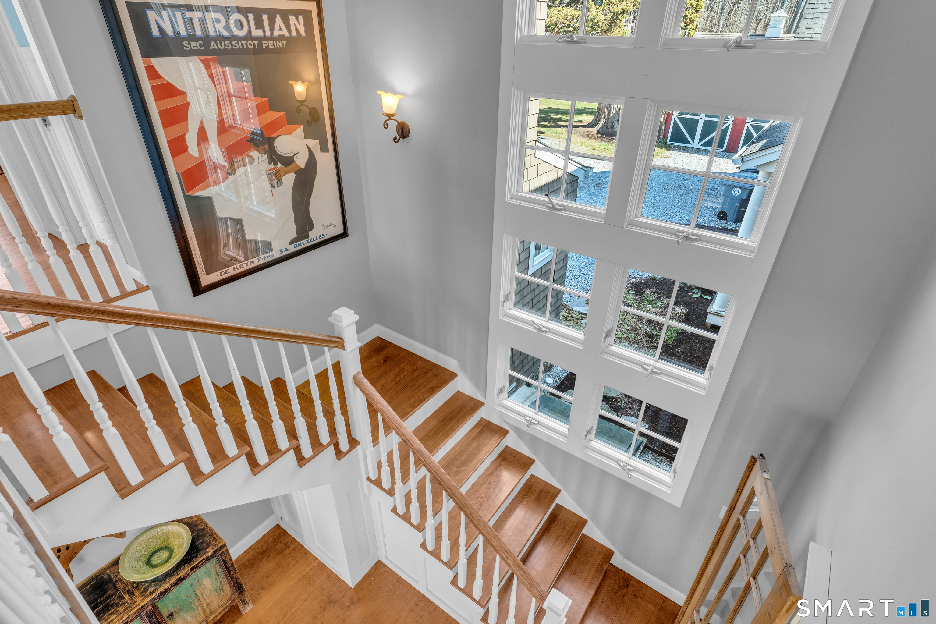 100 Old Black Point Road East Lyme, CT 06357 - Photo 32 of 40 A second staircase leads back to the main living area and is flanked by floor to ceiling windows.