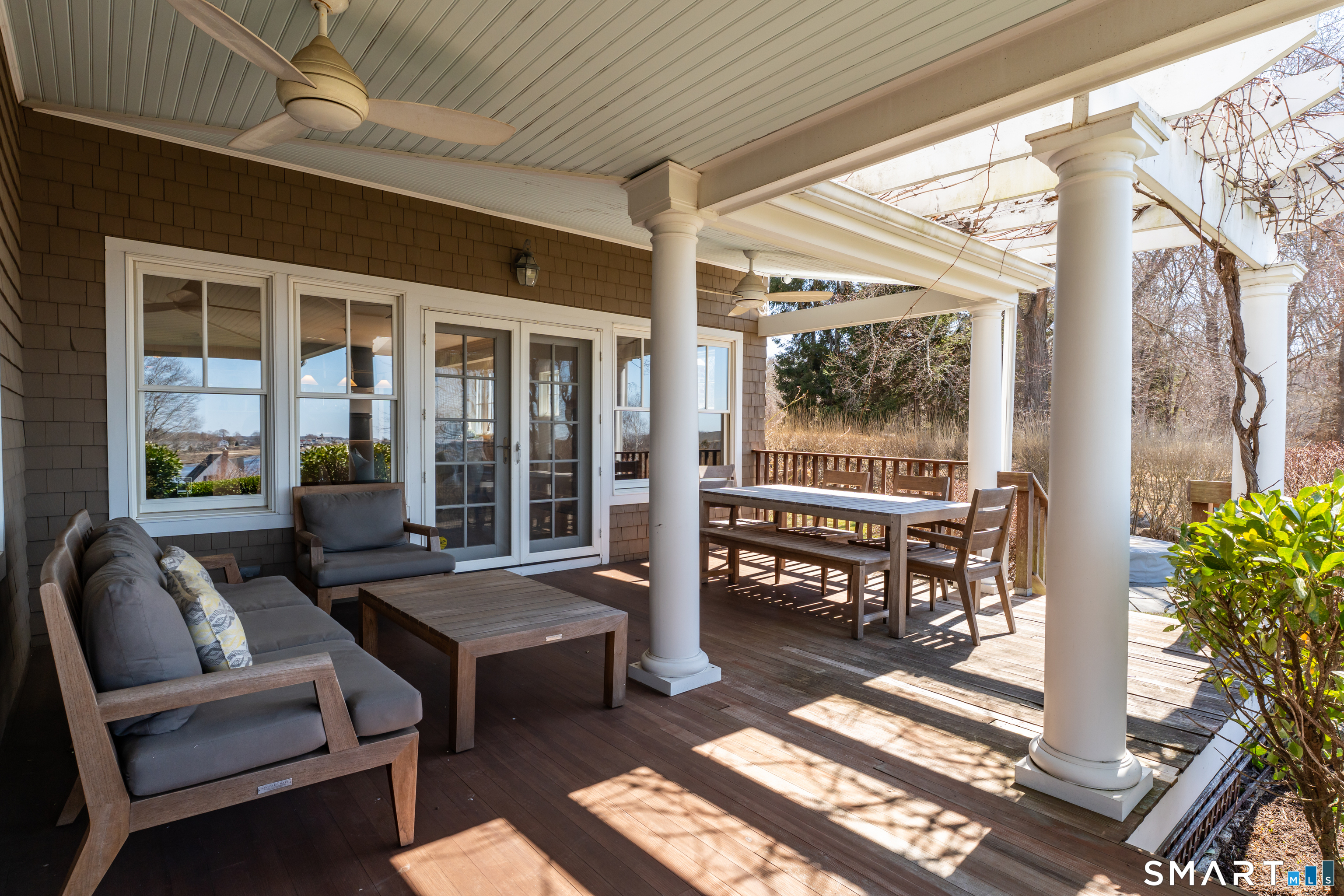 100 Old Black Point Road East Lyme, CT 06357 - Photo 35 of 40 The covered front porch spans the front of the home and offers plenty of seating areas to enjoy the view.