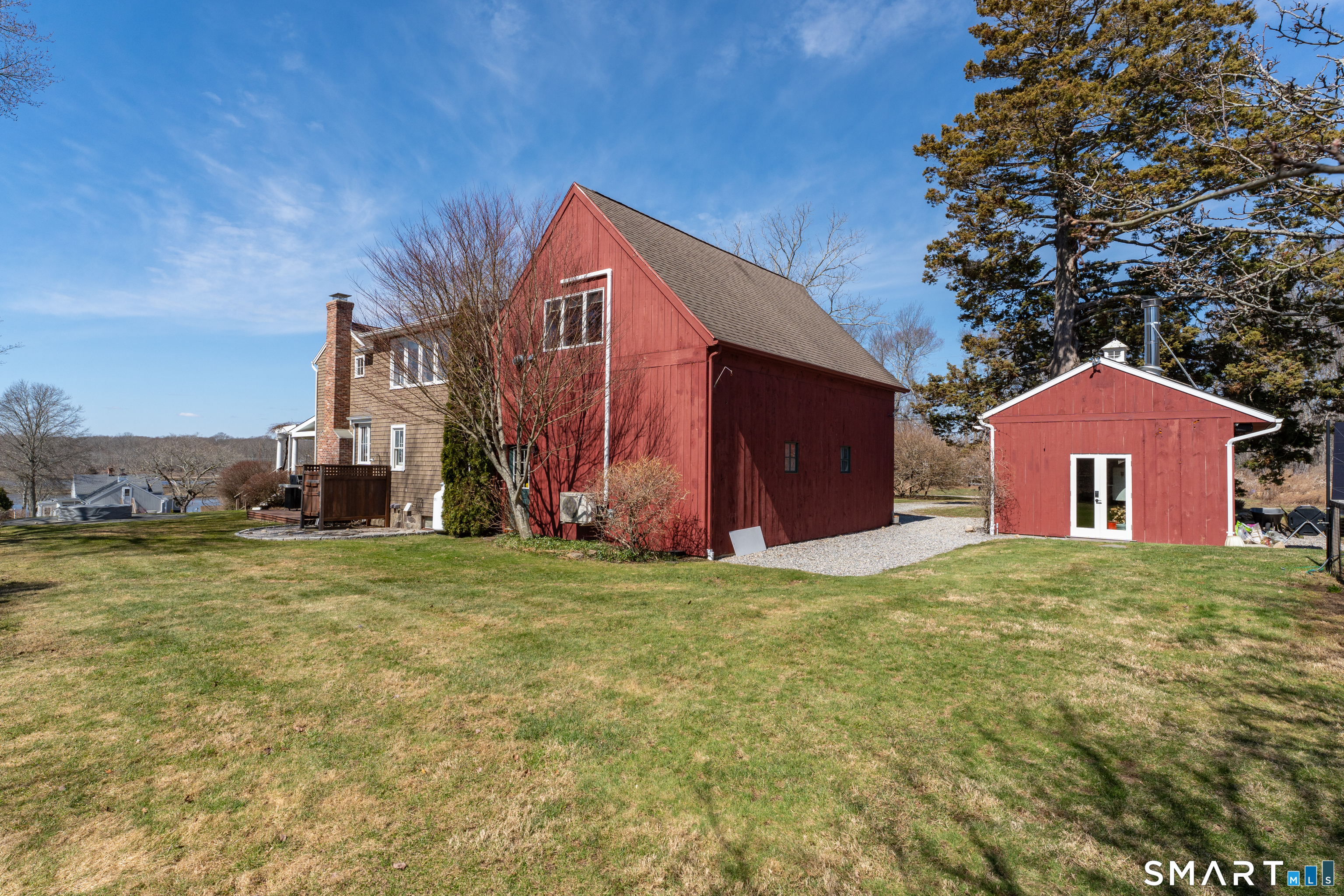 100 Old Black Point Road East Lyme, CT 06357 - Photo 39 of 40 The spacious back yard includes an outdoor shower, a patio, the pizza barn and a playscape area.