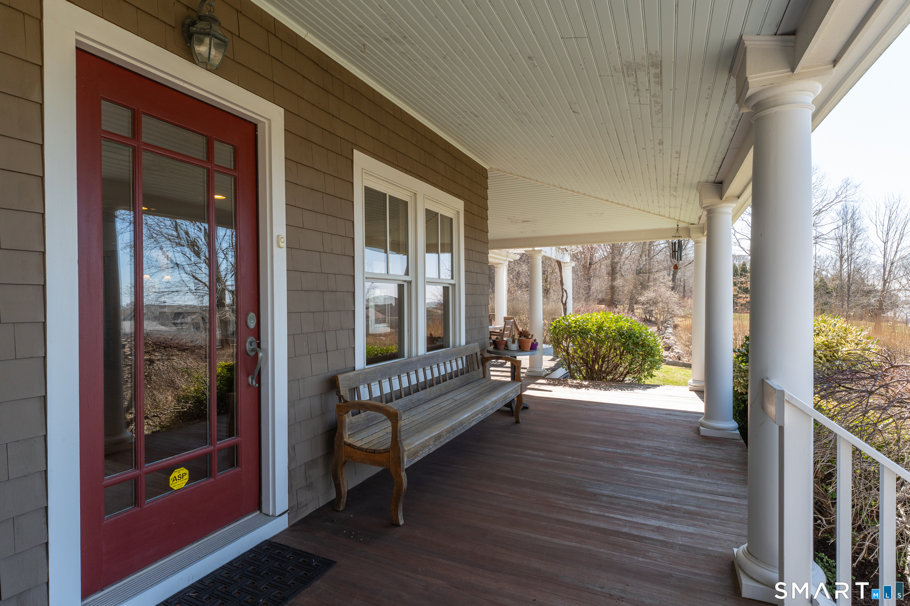 100 Old Black Point Road East Lyme, CT 06357 - Photo 5 of 40 The covered front porch spans the front of the home and offers plenty of seating areas to enjoy the view.