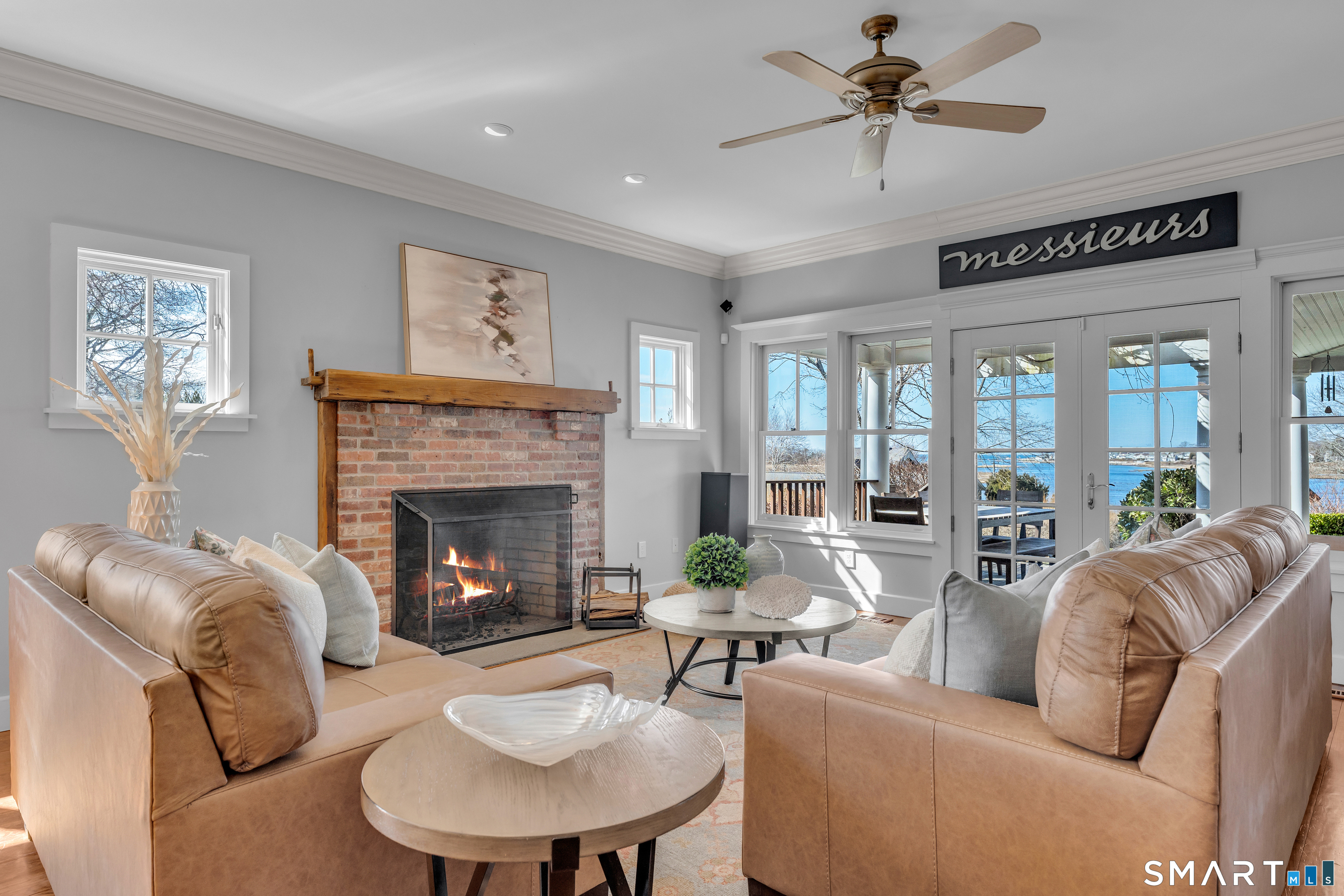 100 Old Black Point Road East Lyme, CT 06357 - Photo 7 of 40 The great room has a wood burning fireplace and spectacular sunset views.