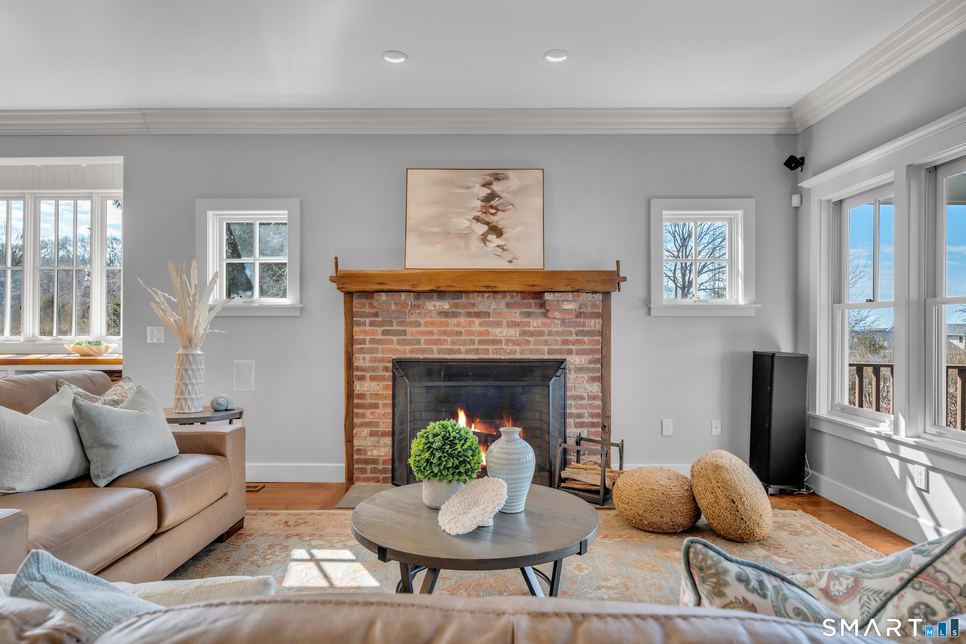 100 Old Black Point Road East Lyme, CT 06357 - Photo 9 of 40 The great room has a wood burning fireplace and spectacular sunset views.