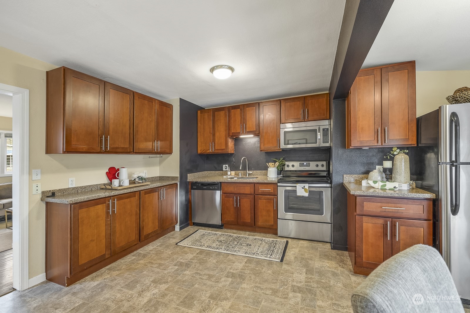 807 Edmonds Avenue Northeast Renton, WA 98056 - Photo 7 of 38 a kitchen with granite countertop a stove top oven sink and cabinets