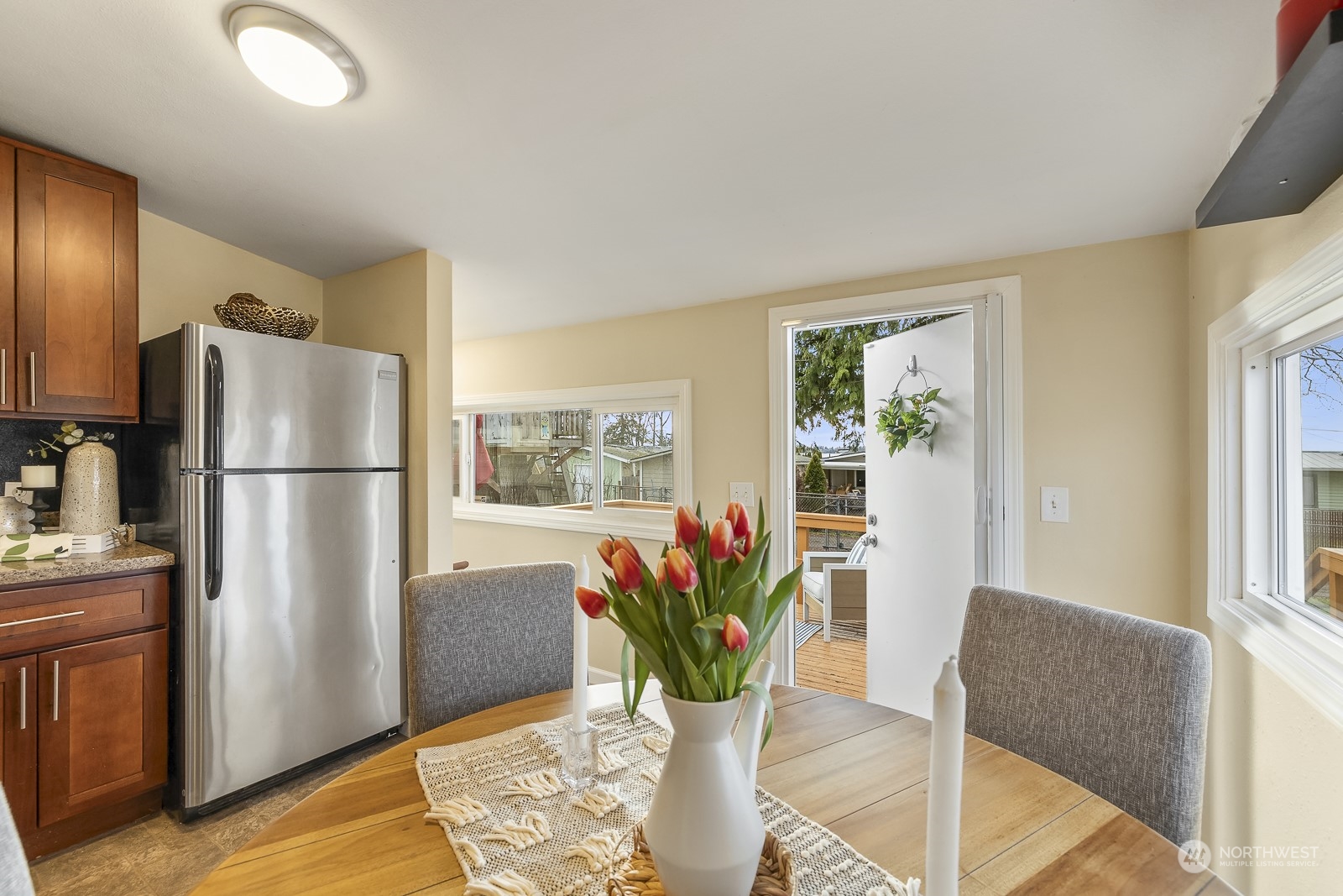 807 Edmonds Avenue Northeast Renton, WA 98056 - Photo 8 of 38 a view of kitchen with stainless steel appliances wooden floor and dining table