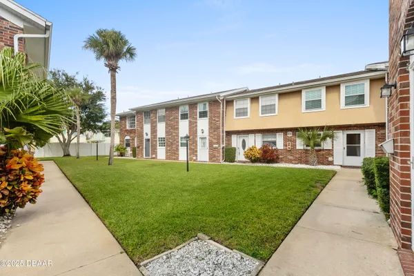 a front view of a house with a yard and porch
