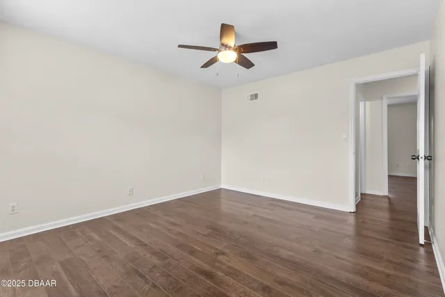 a view of a house with a yard and potted plants
