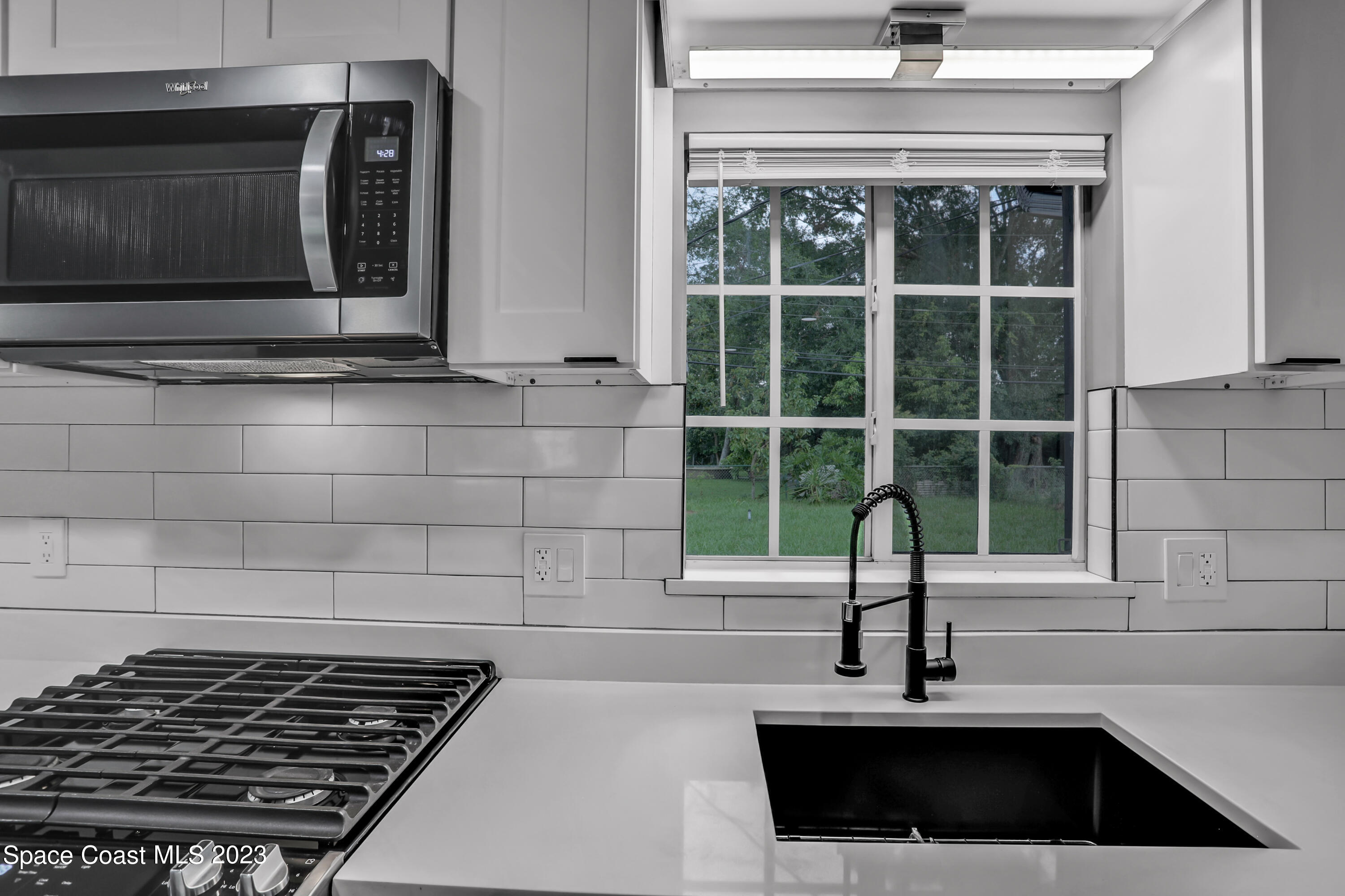 1905 Exeter Drive Cocoa, FL 32922 - Photo 15 of 37 a kitchen with a sink a stove and cabinets
