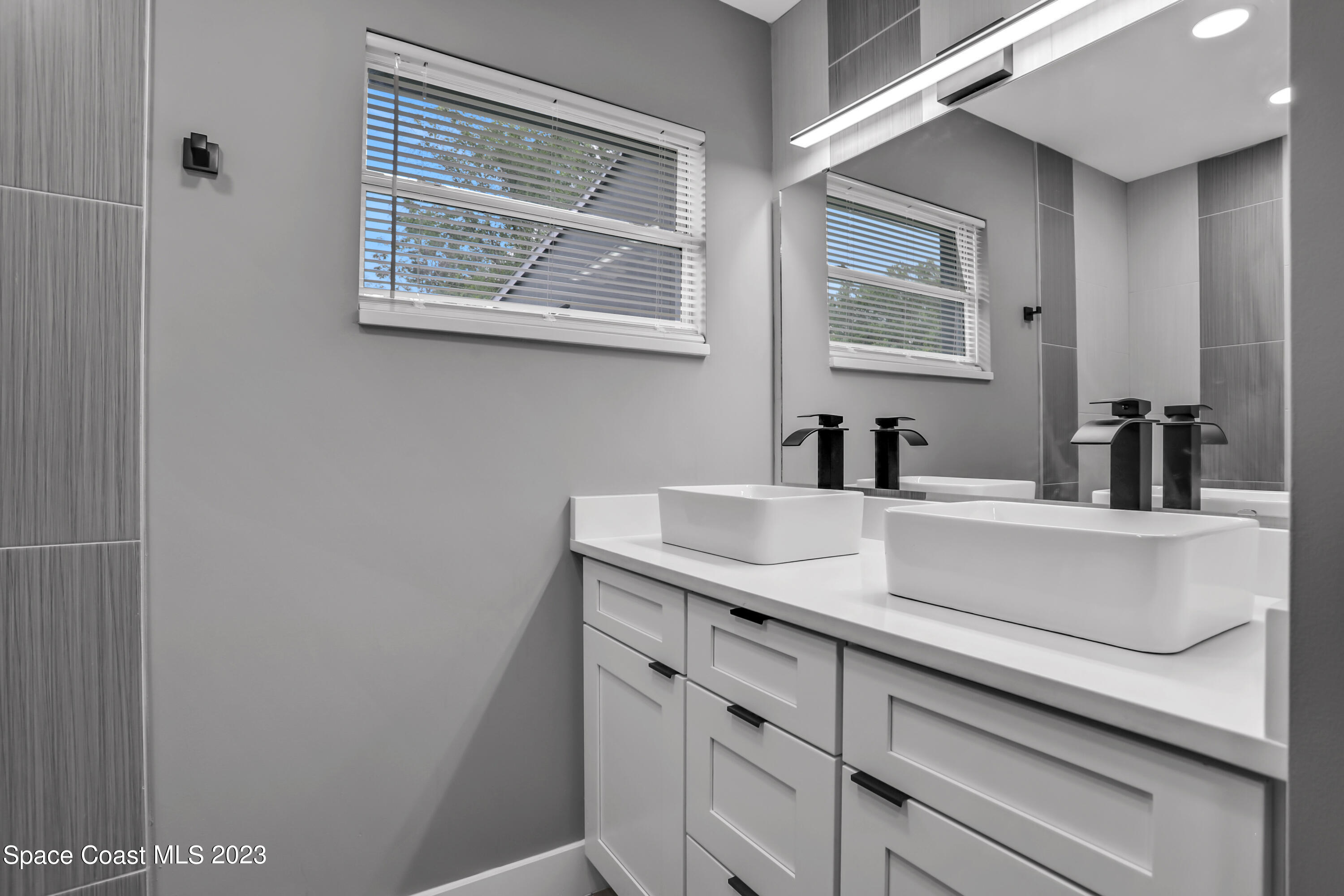 1905 Exeter Drive Cocoa, FL 32922 - Photo 19 of 37 a bathroom with a sink and a mirror