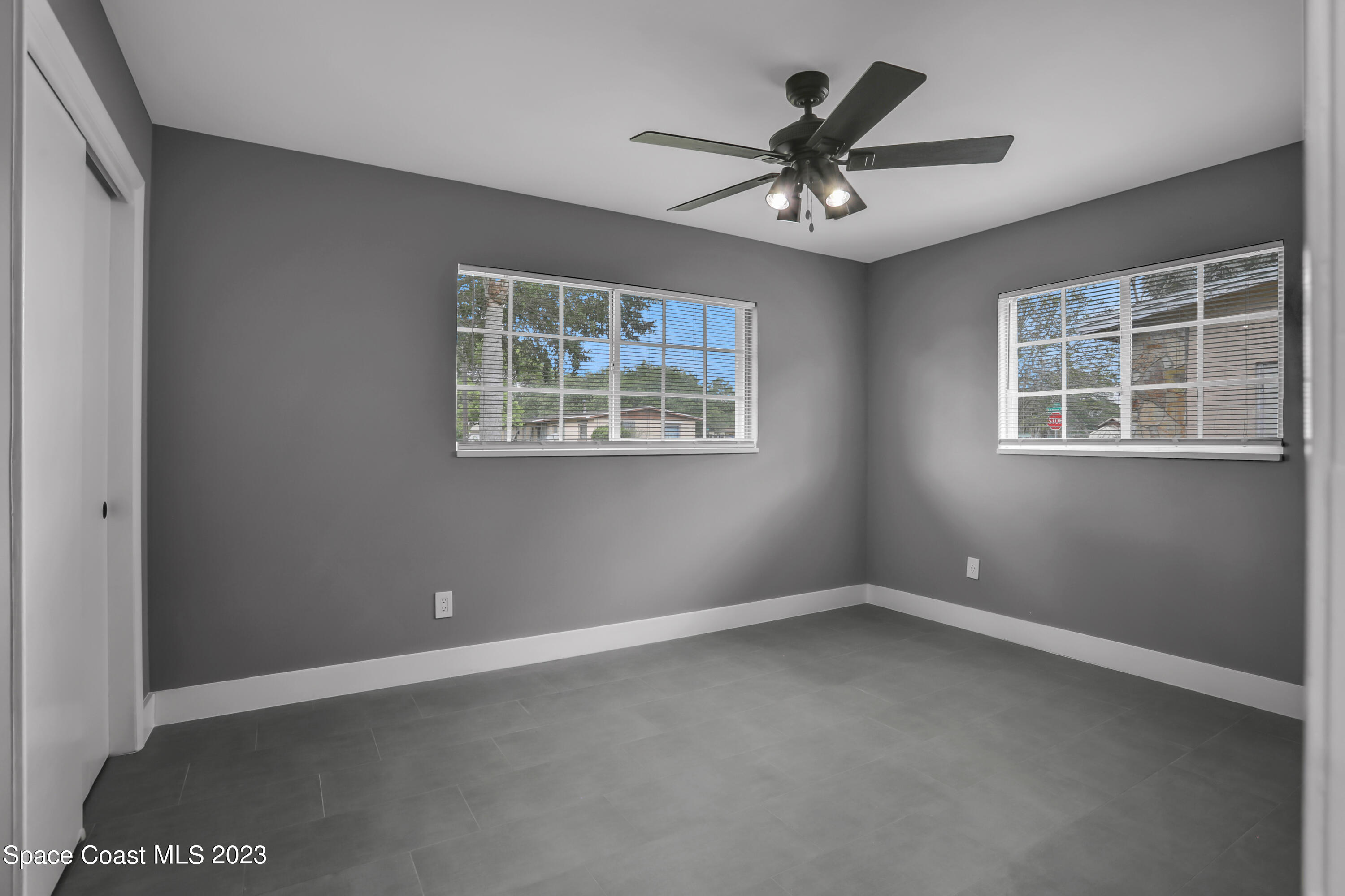 1905 Exeter Drive Cocoa, FL 32922 - Photo 23 of 37 an empty room with window and ceiling fan