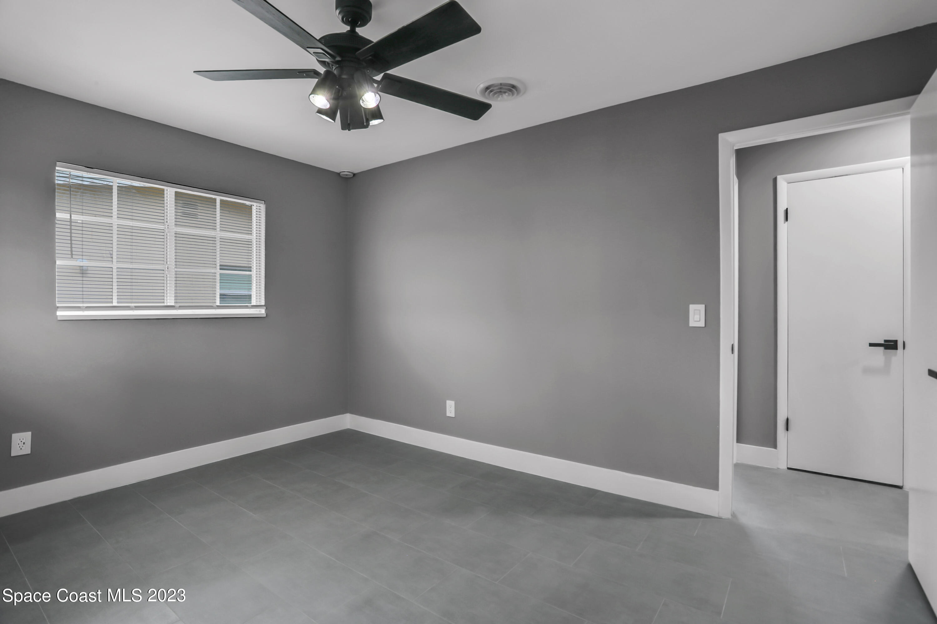 1905 Exeter Drive Cocoa, FL 32922 - Photo 24 of 37 an empty room with windows and a ceiling fan